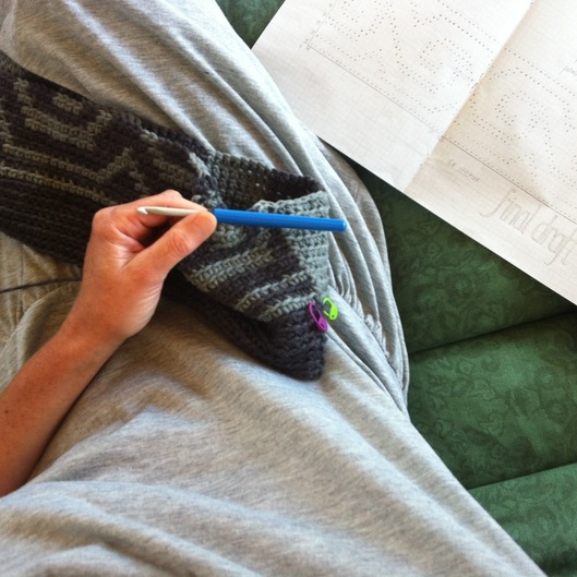 sitting doing crochet from graph 